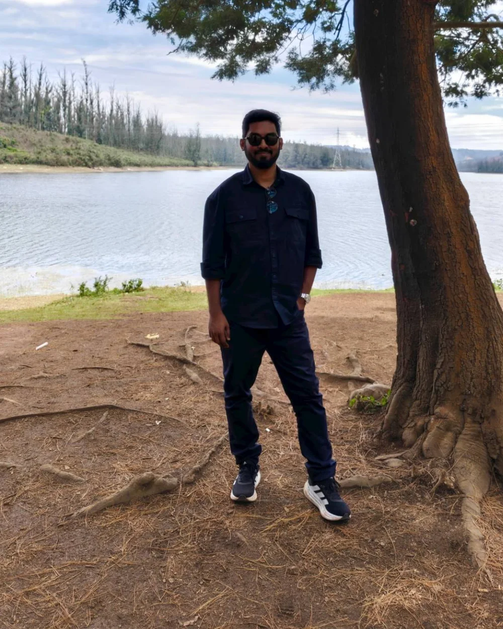 Rizvi Iqbal, co-founder of FOZA Technologies, standing by a lake